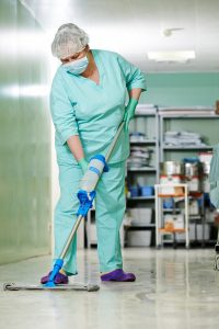 Woman cleaning hospital hall